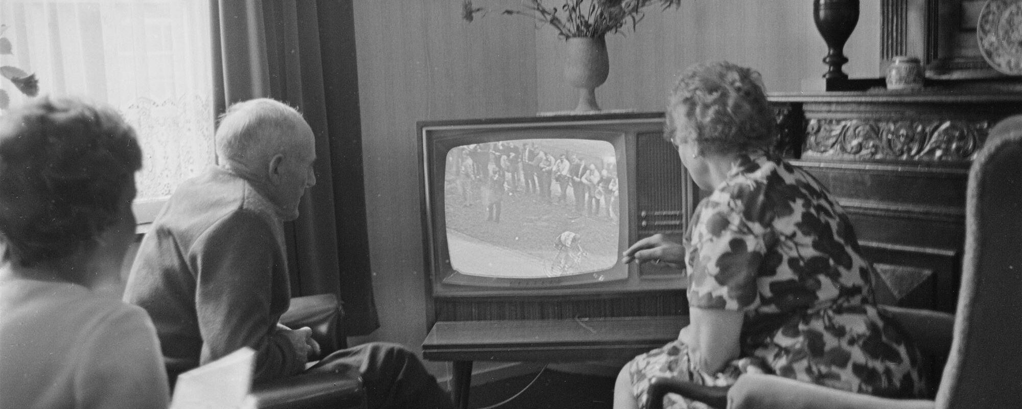 Een gezin kijkt naar de televisie, waar verschillende zuilen een eigen omroep hebben, circa jaren zestig. (Beeld: ANP)